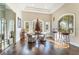 Charming sitting room with hardwood floors, arched windows, and a decorative table and chairs at 2870 Quartz Canyon Dr, Henderson, NV 89052