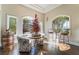 Bright sitting room featuring hardwood floors, arched windows, and a decorative Christmas tree at 2870 Quartz Canyon Dr, Henderson, NV 89052