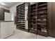 Custom walk-in closet with shoe racks and built-in mirror at 2870 Quartz Canyon Dr, Henderson, NV 89052
