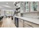 The bar area features cabinets with glass doors and beverage refrigerator at 5873 Skyfall Ct, Las Vegas, NV 89135