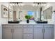 Modern bathroom featuring double sinks, gray cabinetry, and a large mirror at 5873 Skyfall Ct, Las Vegas, NV 89135