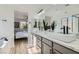 Bright bathroom with double sinks, and view into the adjacent bedroom at 5873 Skyfall Ct, Las Vegas, NV 89135