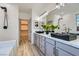 Bathroom boasts dual sinks, white subway tiles, and walk-in closet at 5873 Skyfall Ct, Las Vegas, NV 89135