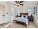 Cozy bedroom with neutral tones, ceiling fan, and an attached bath at 5873 Skyfall Ct, Las Vegas, NV 89135