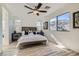 Serene bedroom with natural light, ceiling fan, and views of the mountains at 5873 Skyfall Ct, Las Vegas, NV 89135