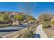Attractive community entrance with walking path and landscaping at 5873 Skyfall Ct, Las Vegas, NV 89135
