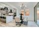 Dining area adjacent to the kitchen features modern lighting and sliding doors to the patio at 5873 Skyfall Ct, Las Vegas, NV 89135