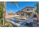 Two-story home with pool and patio furniture at 5873 Skyfall Ct, Las Vegas, NV 89135
