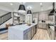 A spacious kitchen features an island, modern appliances, and stylish lighting fixtures at 5873 Skyfall Ct, Las Vegas, NV 89135
