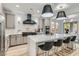 A spacious kitchen features a center island, stainless steel appliances, and an eat-in area at 5873 Skyfall Ct, Las Vegas, NV 89135
