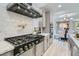 Well-equipped kitchen with a pot filler faucet and stylish cabinetry and appliances at 5873 Skyfall Ct, Las Vegas, NV 89135