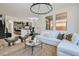 Spacious open floor plan living space features modern decor and seamless flow to the kitchen at 5873 Skyfall Ct, Las Vegas, NV 89135