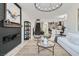Open concept living space with fireplace, contemporary lighting, and view of the kitchen at 5873 Skyfall Ct, Las Vegas, NV 89135