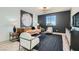 Bright living room features dark accent wall, modern furnishings, window view and striking decorative art at 5873 Skyfall Ct, Las Vegas, NV 89135