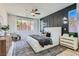 This bedroom features a ceiling fan and large windows overlooking the backyard at 5873 Skyfall Ct, Las Vegas, NV 89135