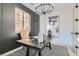 Chic office with striking accent wall, designer lighting, and a comfortable seating area bathed in natural light at 5873 Skyfall Ct, Las Vegas, NV 89135
