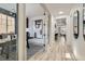 Bright office space with wood flooring, large window, and stylish decor, open to hallway and living space at 5873 Skyfall Ct, Las Vegas, NV 89135