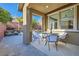 Covered patio with outdoor seating overlooking the pool and landscaped backyard at 5873 Skyfall Ct, Las Vegas, NV 89135