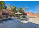 Spacious patio with seating area adjacent to a beautiful pool at 5873 Skyfall Ct, Las Vegas, NV 89135