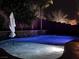 Inviting pool with blue lighting at night, surrounded by landscaping at 5873 Skyfall Ct, Las Vegas, NV 89135