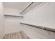 An empty walk-in closet features wooden racks at 5873 Skyfall Ct, Las Vegas, NV 89135