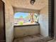 View from an open-air balcony with desert landscaping and trees at 6137 W Oakey Blvd # A, Las Vegas, NV 89146