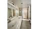Bathroom featuring a dual sink vanity and a glass-enclosed shower at 6137 W Oakey Blvd # A, Las Vegas, NV 89146