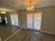 Dining room features gray wood floors, chandelier and patio door at 6137 W Oakey Blvd # A, Las Vegas, NV 89146