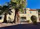 Two-story condo building with palm trees and desert landscaping on a sunny day at 6137 W Oakey Blvd # A, Las Vegas, NV 89146