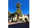 Two-story condo building with palm trees and desert landscaping on a sunny day at 6137 W Oakey Blvd # A, Las Vegas, NV 89146