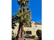 Two-story condo building with palm trees and desert landscaping on a sunny day at 6137 W Oakey Blvd # A, Las Vegas, NV 89146