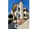 Two story condo featuring neutral tone stucco, private entrance stairs, and well maintained landscaping at 6137 W Oakey Blvd # A, Las Vegas, NV 89146