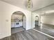 Galley kitchen with white cabinets, white appliances, and adjoining dining area at 6137 W Oakey Blvd # A, Las Vegas, NV 89146
