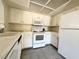 Close up shot of a galley style kitchen featuring white appliances at 6137 W Oakey Blvd # A, Las Vegas, NV 89146