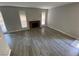 Spacious living room with a fireplace, grey flooring, and natural lighting at 6137 W Oakey Blvd # A, Las Vegas, NV 89146