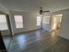 Spacious main bedroom with gray wood floors, ceiling fan, and two windows at 6137 W Oakey Blvd # A, Las Vegas, NV 89146