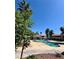 Resort-style pool area with palm trees, lounge chairs and clear blue skies in community at 6137 W Oakey Blvd # A, Las Vegas, NV 89146