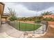 Backyard with an artificial lawn and a -proof fence surrounding the entire landscaped space at 8351 Agave Bloom St, Las Vegas, NV 89131