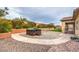 Spacious backyard featuring a hot tub, firepit, desert landscaping at 8351 Agave Bloom St, Las Vegas, NV 89131
