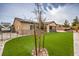 Backyard featuring artificial turf, desert landscaping, and hot tub at 8351 Agave Bloom St, Las Vegas, NV 89131