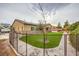 Secluded backyard area showcasing safety fence, trees, and manicured landscape at 8351 Agave Bloom St, Las Vegas, NV 89131