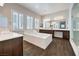 Luxurious primary bathroom with soaking tub, double vanities, and a separate glass shower at 8351 Agave Bloom St, Las Vegas, NV 89131