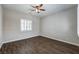 Bright bedroom features wood-look floors, ceiling fan, and window with shutters at 8351 Agave Bloom St, Las Vegas, NV 89131