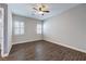 Bedroom with wood-look floors, ceiling fan, and window with shutters at 8351 Agave Bloom St, Las Vegas, NV 89131