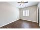 Spacious bedroom features wood-look flooring and a shuttered window at 8351 Agave Bloom St, Las Vegas, NV 89131