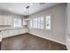 Bright dining area with white cabinets, granite countertops, wood-look tile flooring and plantation shutters at 8351 Agave Bloom St, Las Vegas, NV 89131