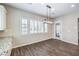Cozy dining area filled with natural light featuring white cabinets, tile flooring and modern light fixture at 8351 Agave Bloom St, Las Vegas, NV 89131