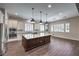 Modern kitchen with a large island, stainless steel appliances, and stylish pendant lighting at 8351 Agave Bloom St, Las Vegas, NV 89131