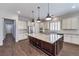 Spacious kitchen featuring a granite island, stainless appliances, and sleek white cabinets at 8351 Agave Bloom St, Las Vegas, NV 89131