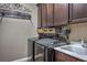 Convenient laundry room with modern washer, dryer, sink, and custom cabinetry for storage at 8351 Agave Bloom St, Las Vegas, NV 89131